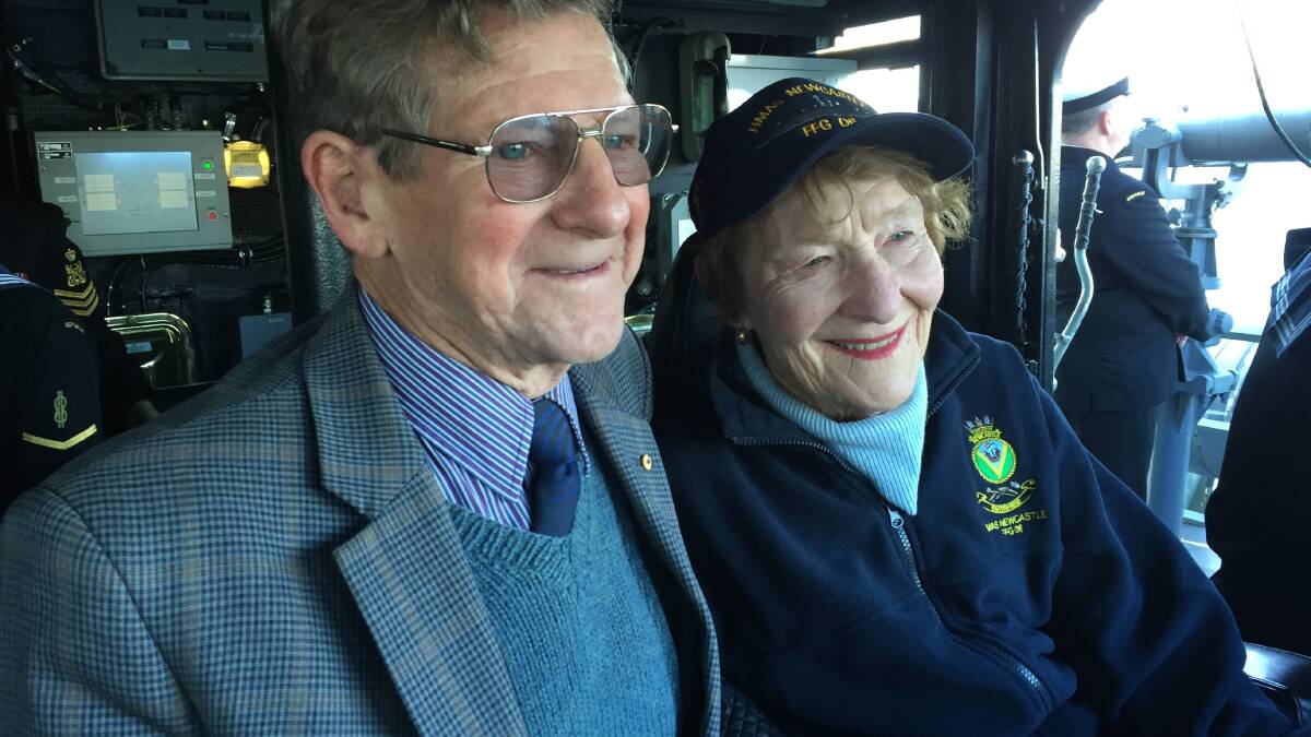 POWER COUPLE: John and Margaret McNaughton on the bridge of HMAS Newcastle, as the ship approaches Garden Island for the final time. Picture: Scott Bevan