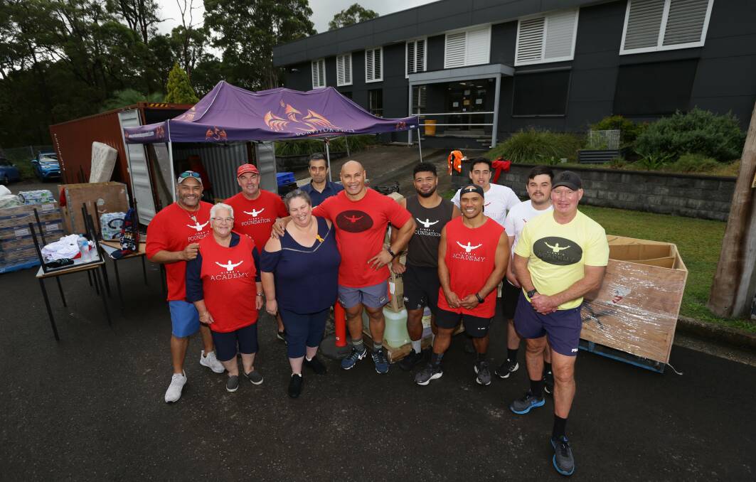 TEAM FOR TONGA: Sione Finefeuiaki, centre, with some of the volunteers helping pack containers with donated goods for the island kingdom, which was hit by a tsunami in January. Pictures: Jonathan Carroll 