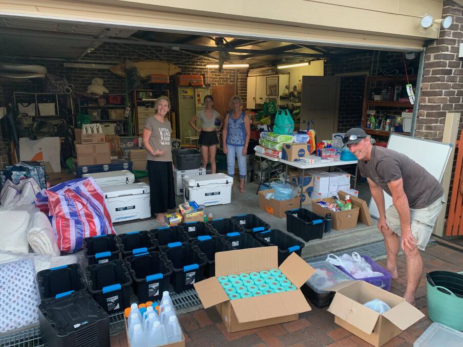 Matt Forde, with family members and fellow Redhead residents, sorting the donated items for the northern NSW flood-ravaged communities. Picture: Kylie Amos 