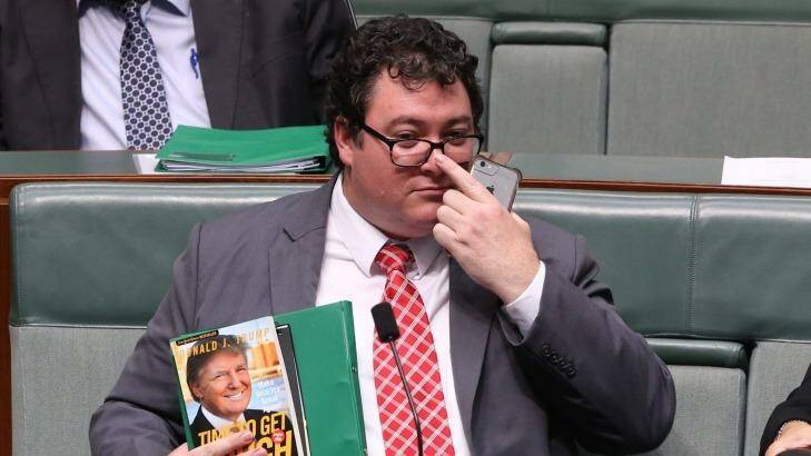 George Christensen holds a Donald Trump book during question time on Wednesday. Photo: Andrew Meares