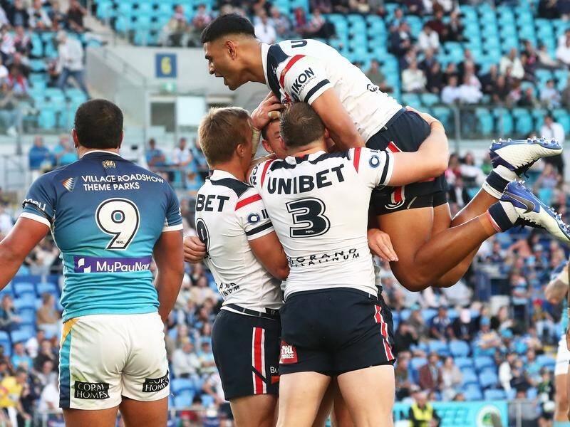 The Roosters have hung on to score a dramatic one-point win over the Titans on the Gold Coast.
