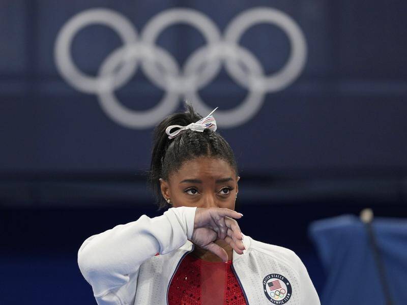 Simone Biles says her mind and body are not in sync as she weighs up whether to press on in Tokyo.
