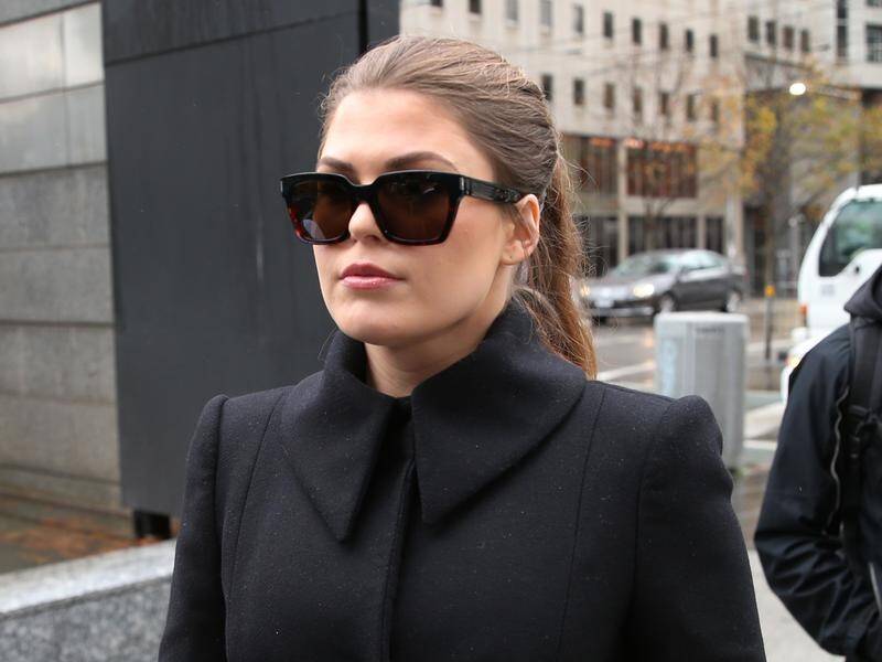 Con artist Belle Gibson cried in court when questioned about her role caring for a mystery woman.