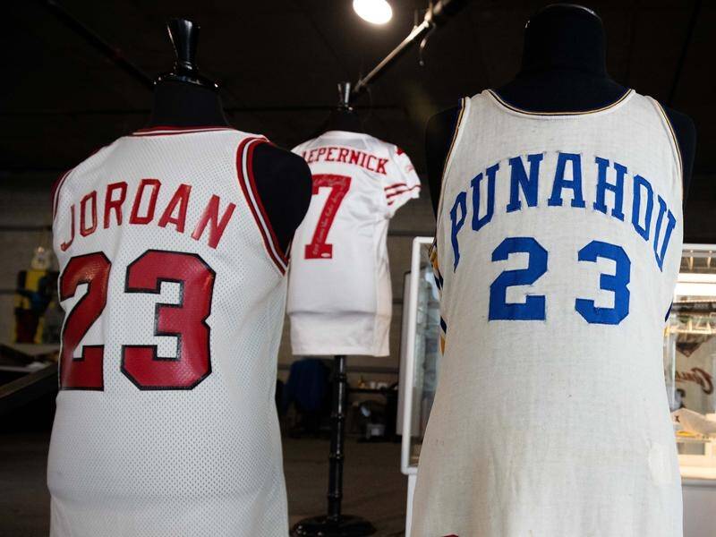 A collection of jerseys, including one worn by Barack Obama, have set records at a US auction.