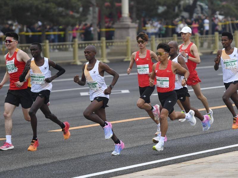 He Jie (c) runs in the Beijing Half-Marathon, at which it is claimed he was 'allowed' to win. (AP PHOTO)