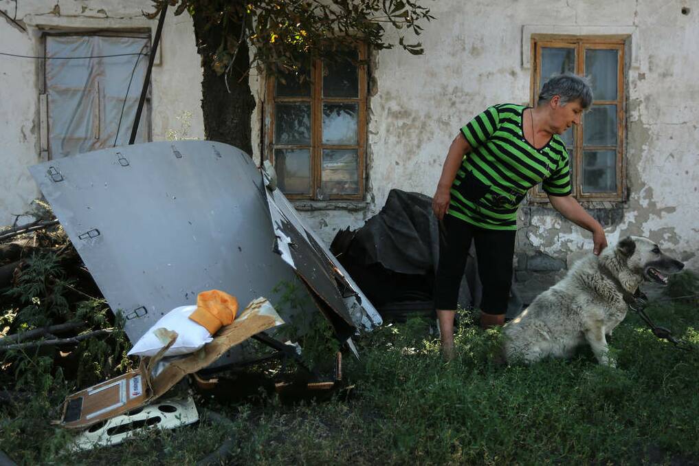 Galina Gurbych stands infront of her home where a farm worker brought MH17 debris for safe keeping from the field he was working in, near the town of Rassypnoye. Photo: Kate Geraghty