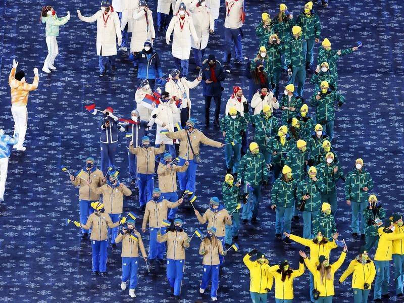 The green-and-gold clad Australian team marching at the Winter Olympics closing ceremony.