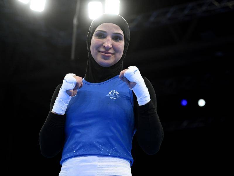 Tina Rahimi enjoys the spotlight after her landmark Commonwealth Games boxing victory. (James Ross/AAP PHOTOS)