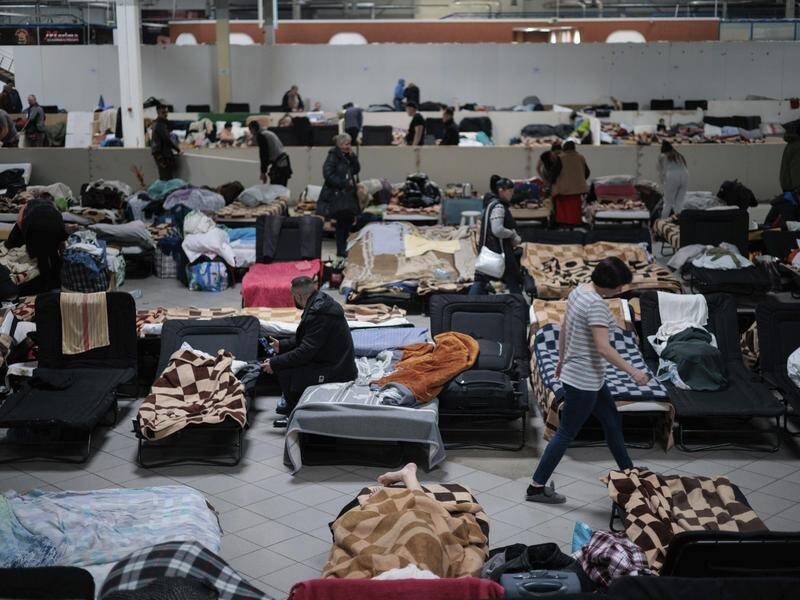 Refugees fleeing conflict, such as these Ukrainians in Poland, have raised numbers to a record high. (AP PHOTO)