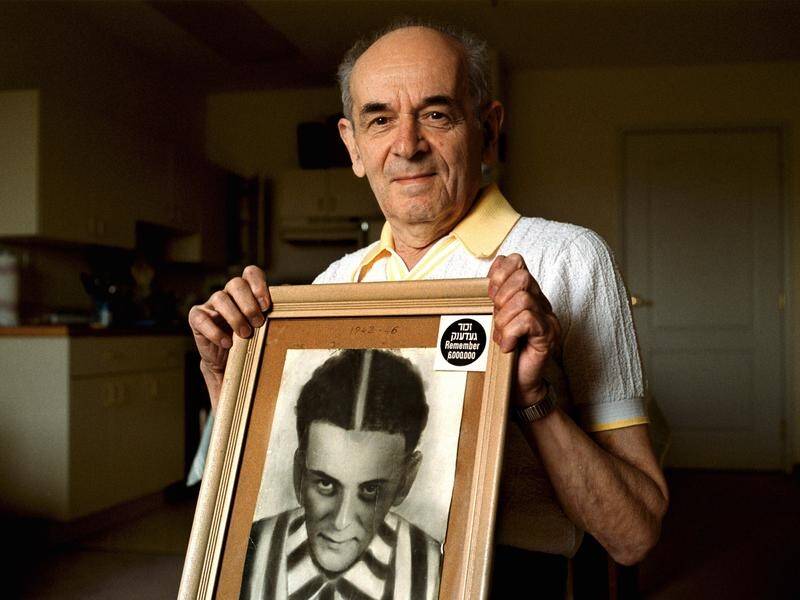 Alter Wiener, seen in 2001, with a photo of himself taken two months after he was liberated in 1945.
