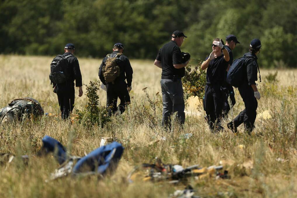 Australian Federal Police and their dutch counterparts searching at the MH17 crash site for human remains in order to bring them home. Photo: kate geraghty