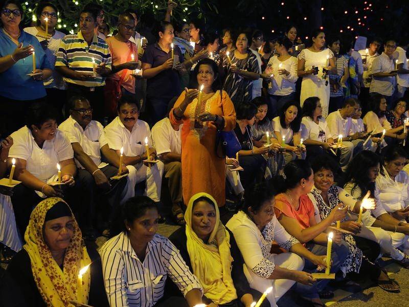 Sri Lankans take part in a candle light vigil in Colombo demanding the restoration of democracy.