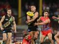 Dion Prestia of the Tigers handballs during the narrow defeat by Sydney Swans.