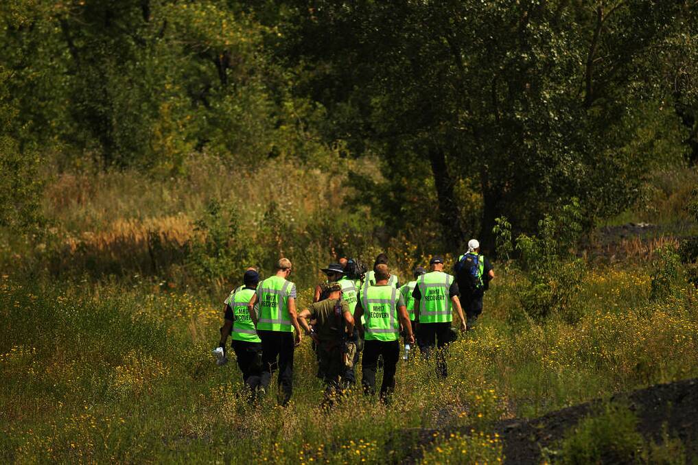 OSCE, Australian Federal Police and their Dutch and Malaysian counterparts, start searching near a slag heap for human remains of passengers from the MH17 crash. Photo: Kate Geraghty