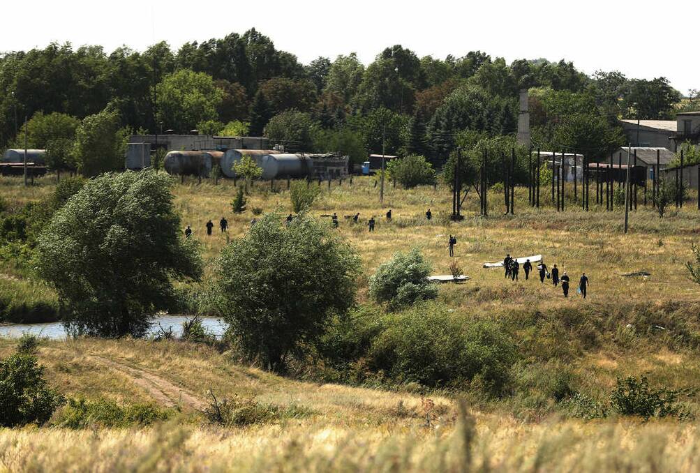 Australian Federal Police and their dutch counterparts searching at the MH17 crash site for human remains in order to bring them home.. Photo: Kate Geraghty