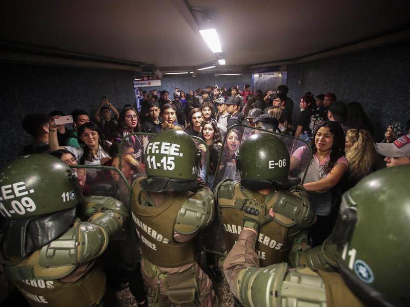 Chile's subway has been suspended following violent protests over a government fare hike.