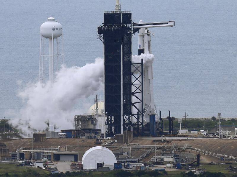A planned SpaceX launch of two astronauts was halted shortly before lift-off because of bad weather.