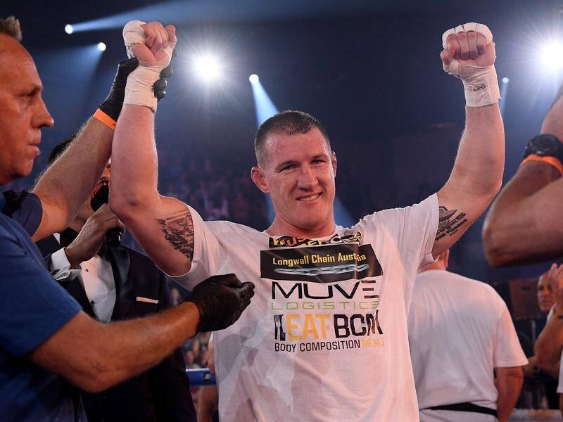 Paul Gallen's arm is raised after knocking out former world champion Lucas Browne in round one.