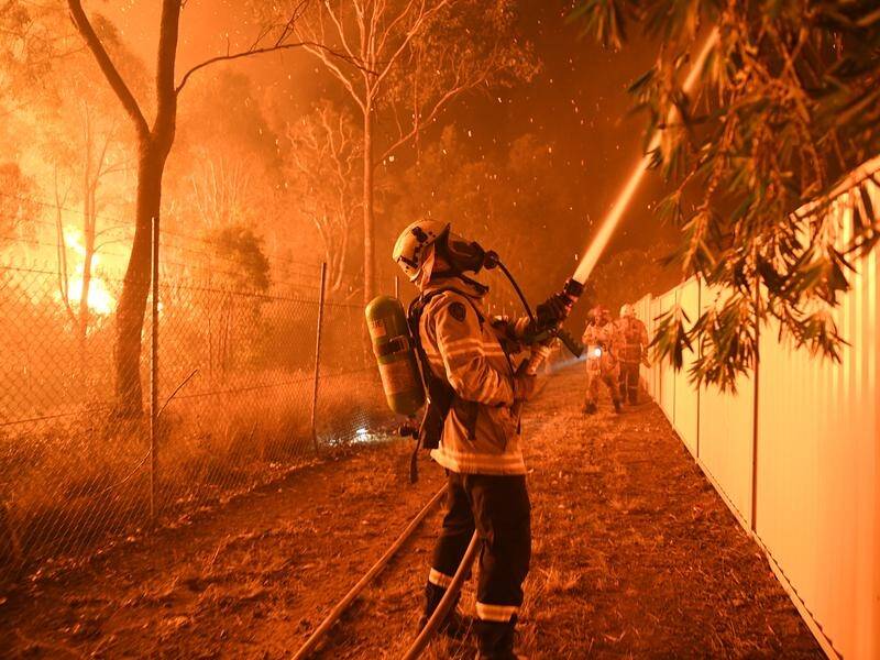 Southwest Sydney's bushfire alert has been downgraded, but fires continue to burn near homes.