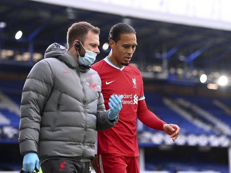 Liverpool's Virgil van Dijk hobbles off after suffering a serious knee injury against Everton.