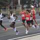 He Jie ( red shirt, centre) runs with four Africans in last weekend's Beijing Half Marathon. (AP PHOTO)