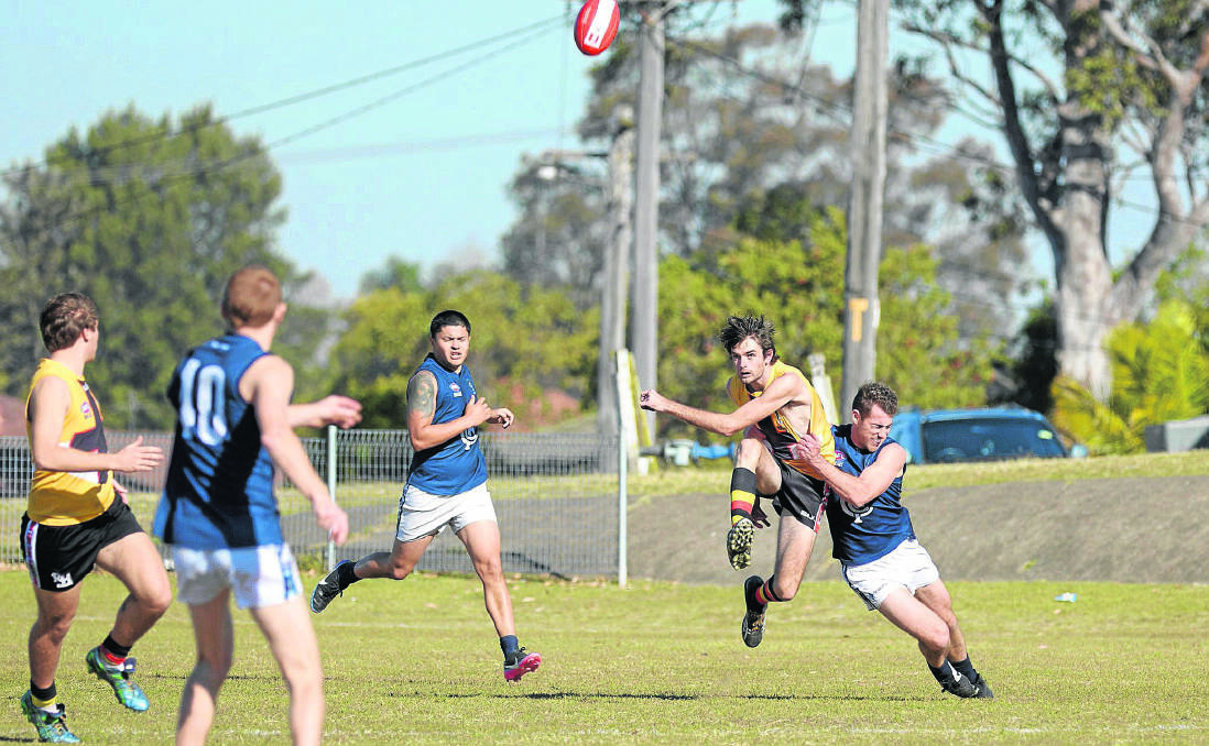 Maitland key defender Andrew Elbourn clears the ball from the defensive 50 against Newcastle City. 