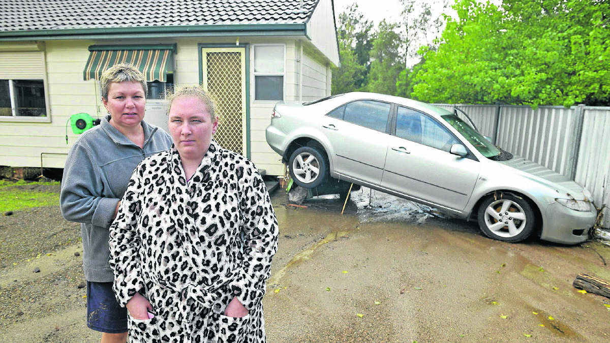 SAFE WITH MUM: Kay Hipwell with her daughter Stacy after water engulfed their home in Hunter Close at Lochinvar.  	Picture by STUART SCOTT  