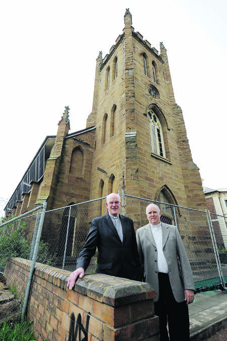 HERITAGE: Bishop Bill Wright and Father Paul O’Neill in front of the Gothic 1840s church.  
