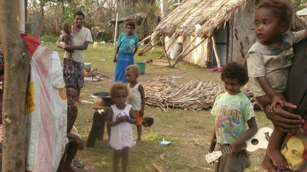 AFTER THE STORM: Nurak “Charlie” Charley (in the green T-shirt) celebrated his birthday the day before Cyclone Pam struck his island home in Vanuatu.