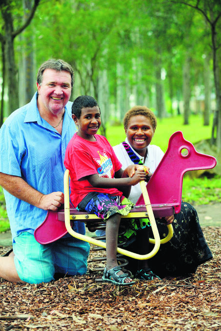UP AND RUNNING: Nurak Charley with his mother  Veronica Iak and East Maitland Rotary Club president Brian Coffey.    Picture by stuart scott 040414SS019 