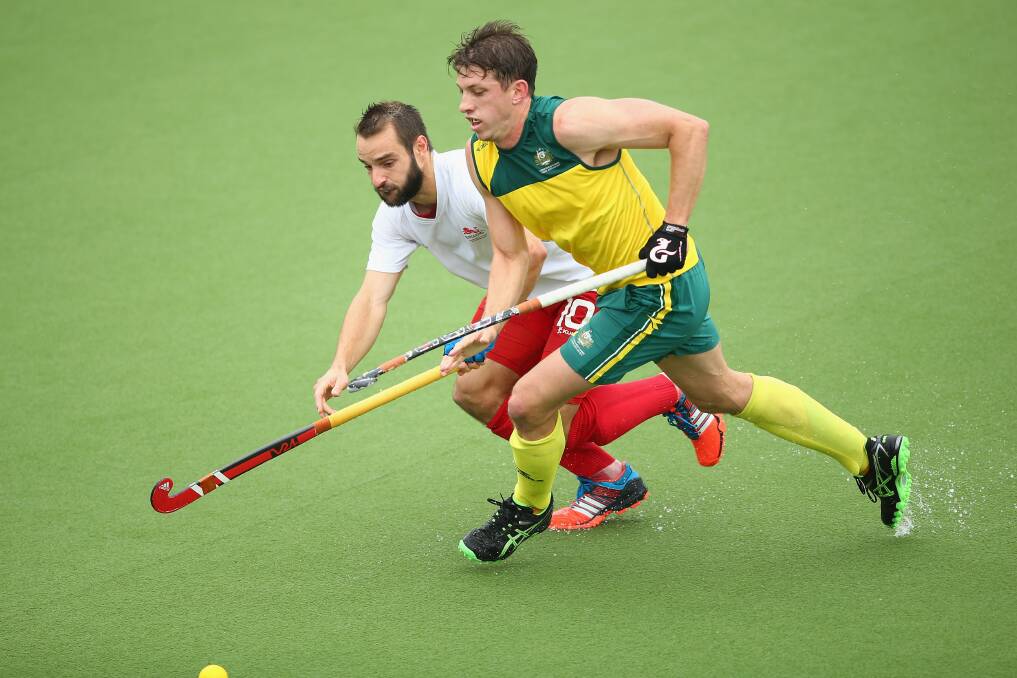 GOING FOR GOLD: Simon Orchard battles for the ball with Nick Catlin of England during the Men's Semi-Final match between Australia and England at Glasgow National Hockey Centre.