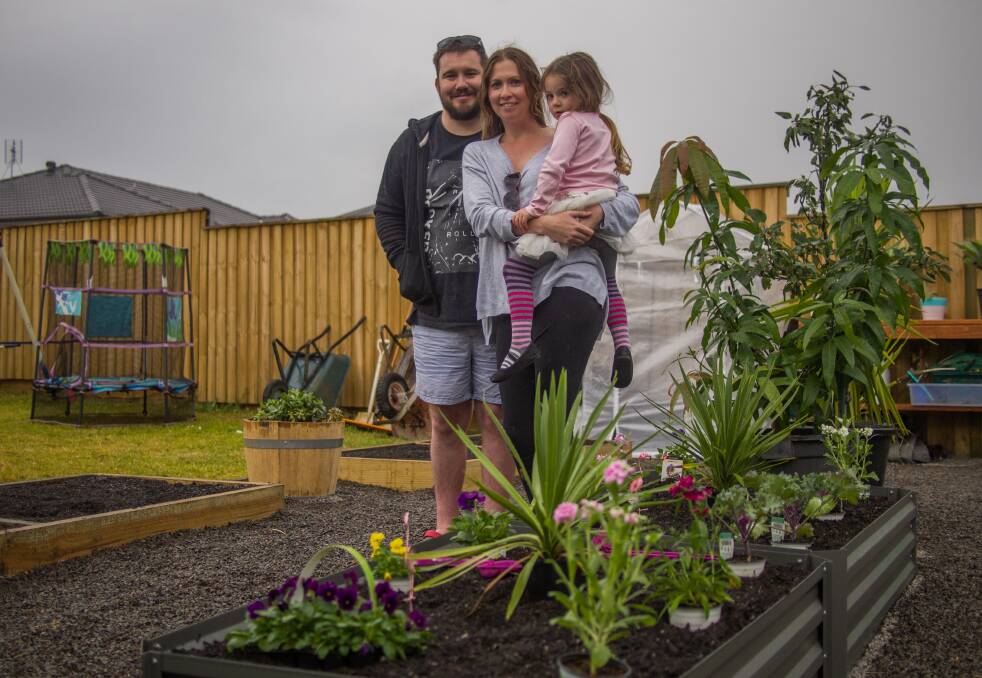 Overwhelmed: Craig, Cindy and Cleo, 4, Austin in their new backyard. Picture: Nick Bielby