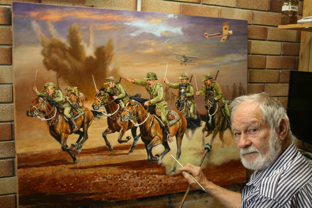 At work: Artist Ron Marshall painting Charge. Picture: Supplied