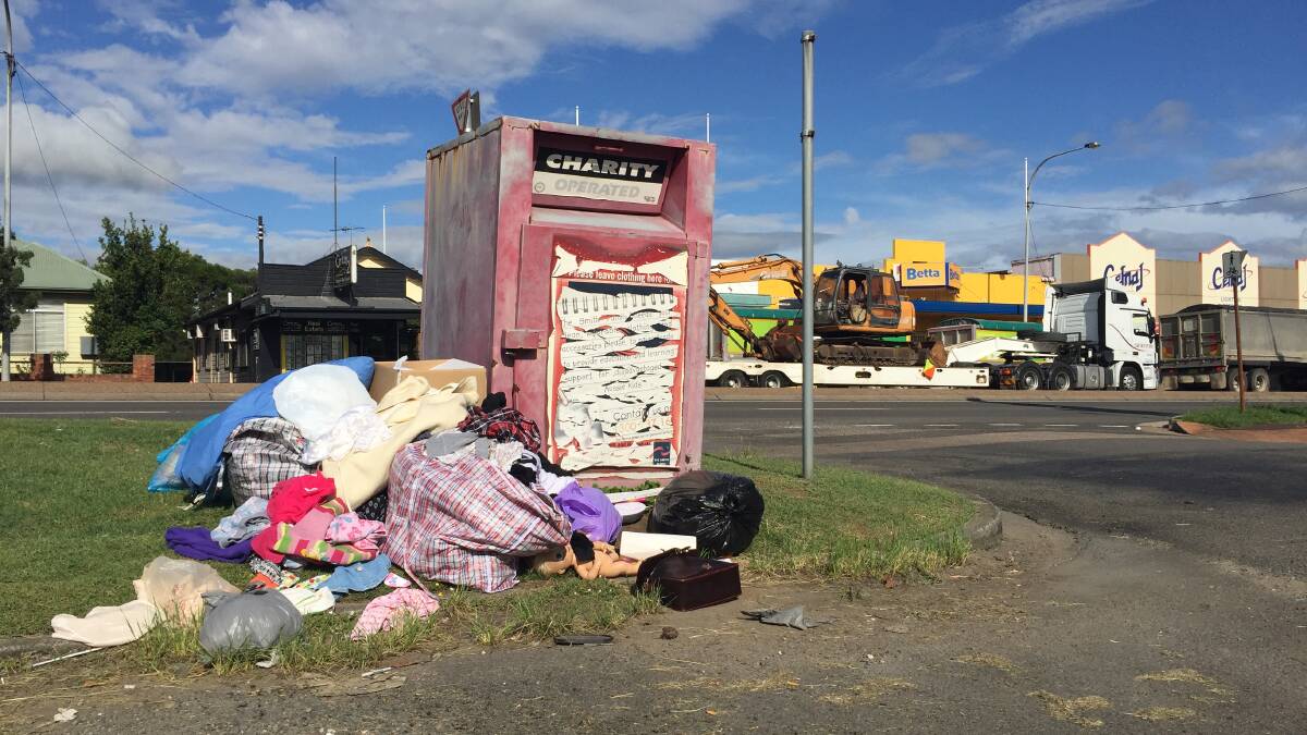 Mess: Items dumped around the Smith Family charity bin at East Maitland, near the Les Darcy statue last week.
