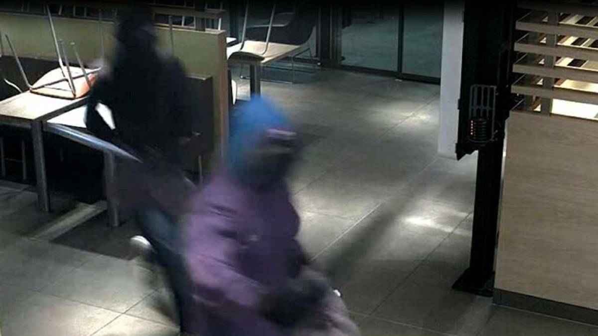 GRAINY: Security vision shows two of the armed robbers who held up the McDonald's restaurant at Williamtown.
