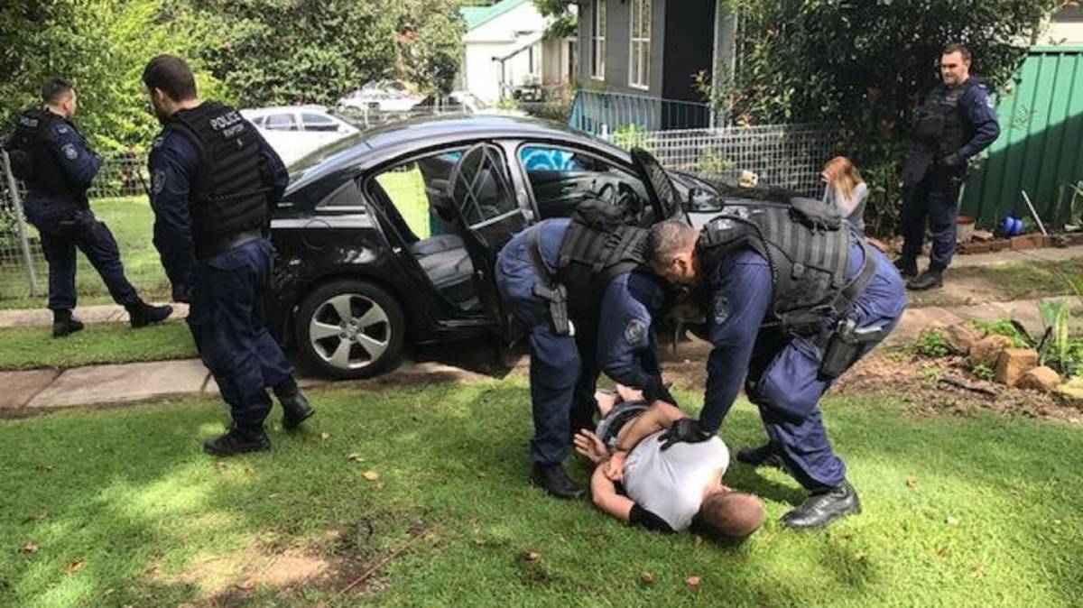 GUILTY: Luke William John Swain is arrested outside a home in Edinburgh Street at Raymond Terrace in April, 2017. He pleaded guilty to counts of armed robbery in company and on Friday was jailed for a maximum of nearly seven years. Picture: NSW Police