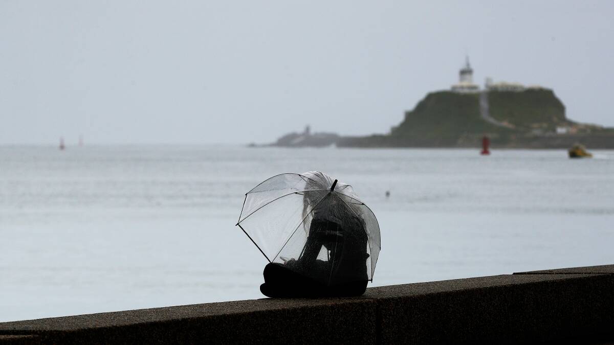 Despite the rain, people were still out and about in Newcastle on Friday, April 5. Picture by Peter Lorimer
