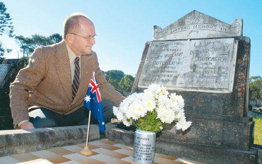 MINI SUB VICTIM: Historian David Dial at the grave of Leading Stoker Sydney William Butcher.  Pic: CATH BOWEN