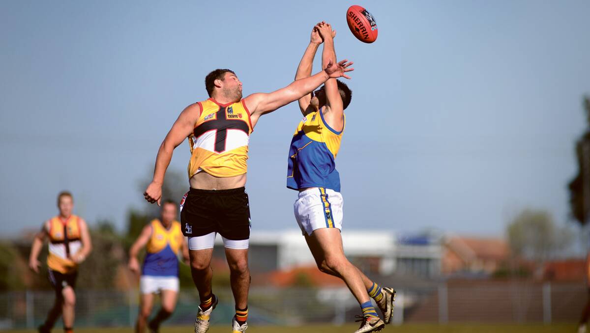 STRONG FINISH: Maitland’s Mark Haebich and Nelson Bay’s Joel Erickson go high for  a mark at Max McMahon Oval on Saturday.  