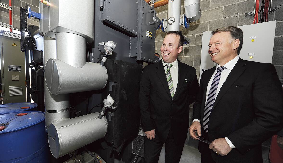 CLEAN AND GREEN: Maitland City Bowls Sports and Recreation Club CEO Ian Martin shows Hunter MP Joel Fitzgibbon the club’s trigeneration energy system.  	