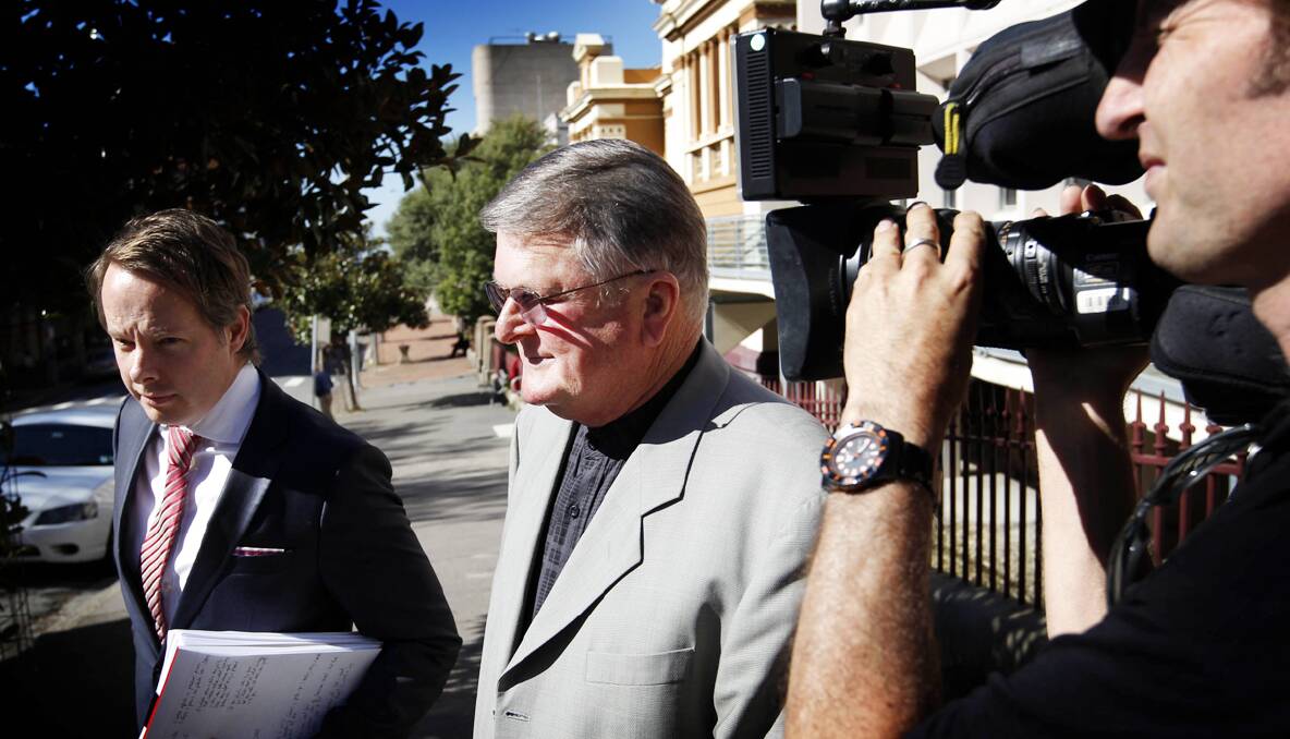 DEFINITE: Father Bob Searle leaves the special inquiry yesterday after saying he had never told police a distressed man had accused priests of doing “filthy” things to children. 