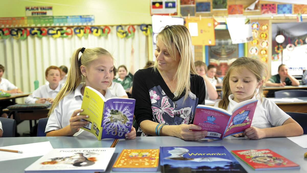 LOVE OF BOOKS:  Author Aleesha Darlison with Metford Public School pupils Aaliyah Mapstone, 11 (left), and Nikita O’Brien, 10, encourages children to  pursue their writing dreams.  	Picture by MARINA NEIL 180912MN105 