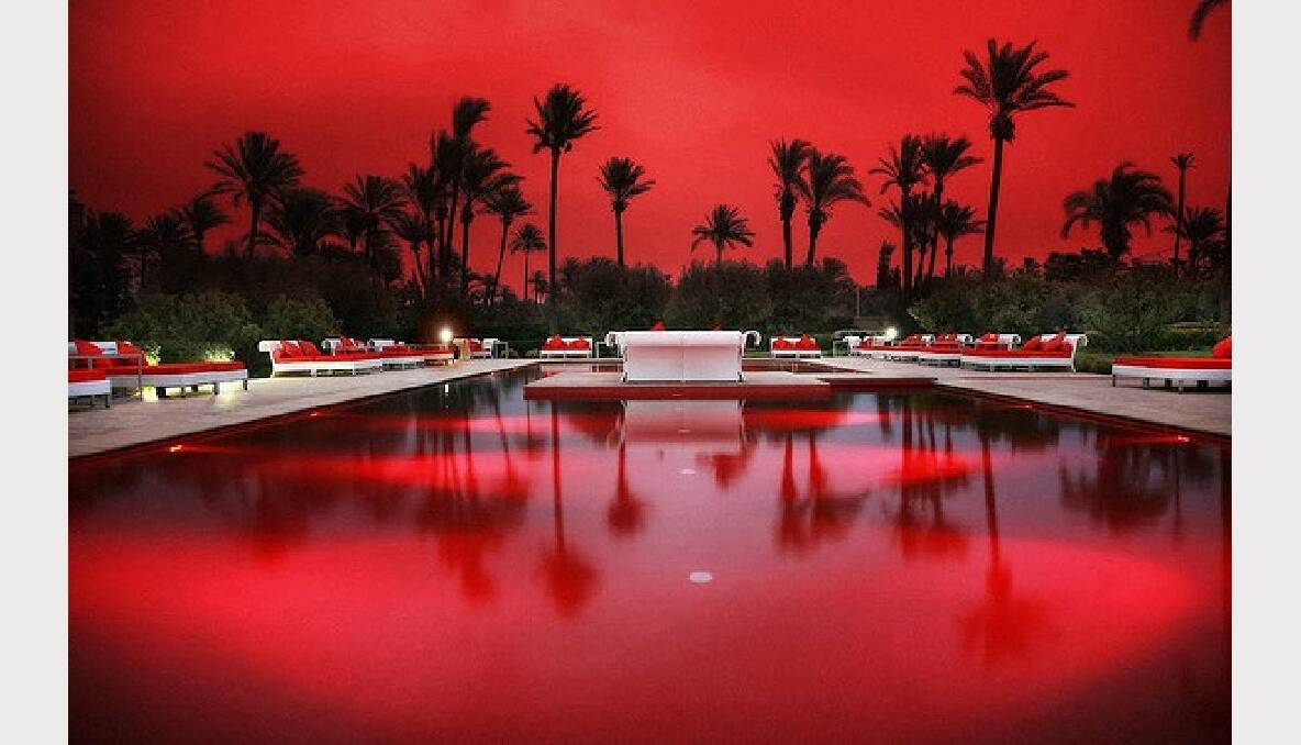 Set among hibiscus and bougainvillea, the red-tile pool is especially striking at night, when red lights add a extra ruby glow at the Murano Oriental Resort in Marrakech, Morocco.