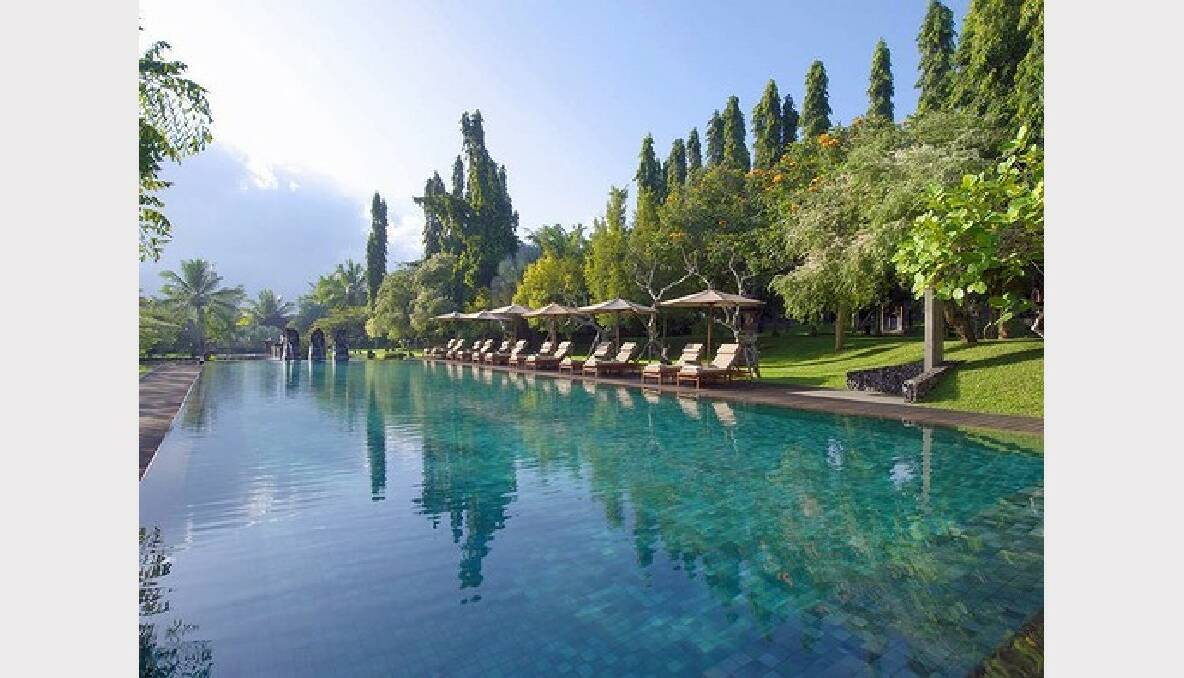 Jungle hills and rice paddies surround the 25-metre pool at the Chedi Club outside Ubud, Bali.
