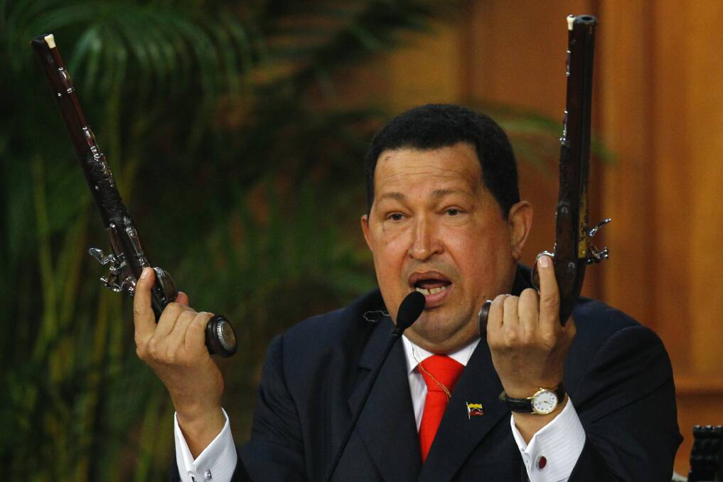 Venezuela's President Hugo Chavez shows the pistols of independence hero Simon Bolivar during a ceremony to mark his birthday in Caracas in July, 2012. Photo: REUTERS/Carlos Garcia Rawlins