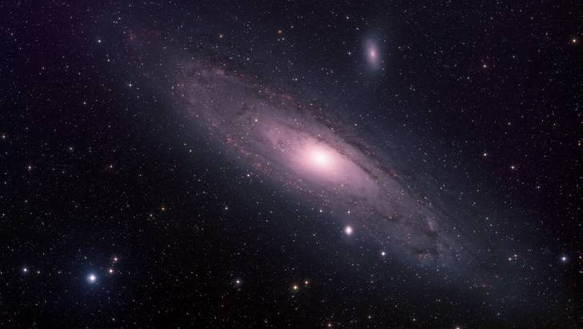 The Andromeda Galaxy is a spiral galaxy about 2.5 million light years from Earth in the Andromeda constellation. Distance to Earth: 2,538,000 light years · Age: 9 billion years · Magnitude: 3.44 · Stars: 1 trillion. 				                   Picture: Snaevarr Gudmundsson